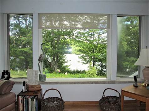 View of Lake From Picture Window With Blinds